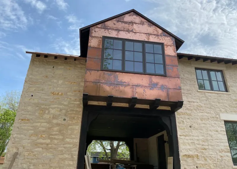 Copper metal panel facade on a stone building for Metal Roof Coating in Mead